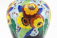 CHARLES-CATTEAU-FOR-BOCHE-FRERES-CERAMIC-VASE-DECORATED-WITH-FLOWERS-Balustroid-with-orange-and-yellow-flowers-against-a-pale_1572023216_5615